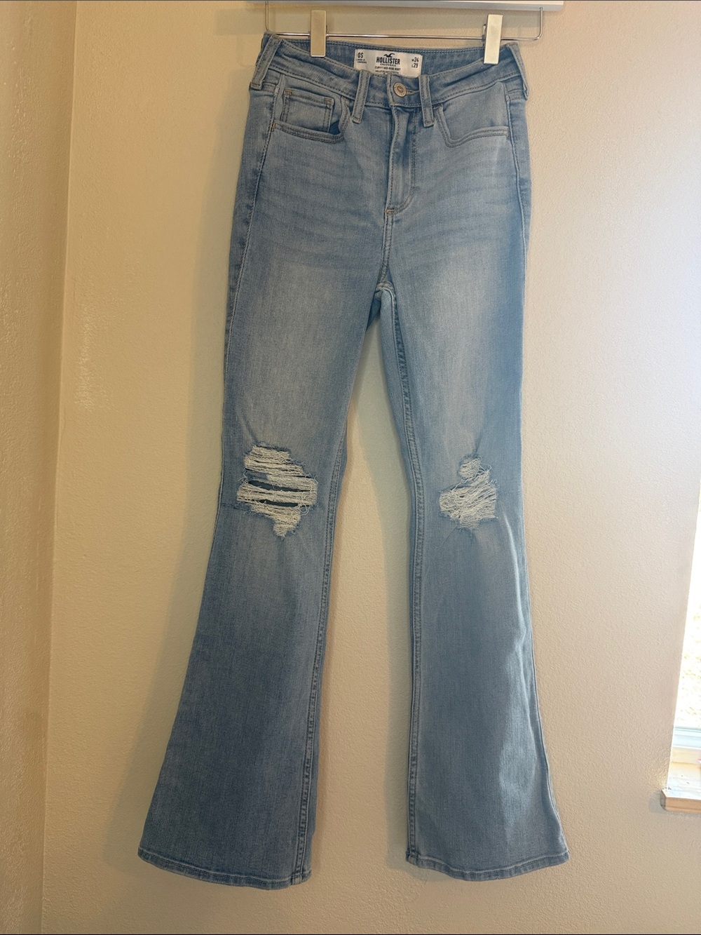 9. High-Rise Light Blue Distressed Flare Jeans - Women